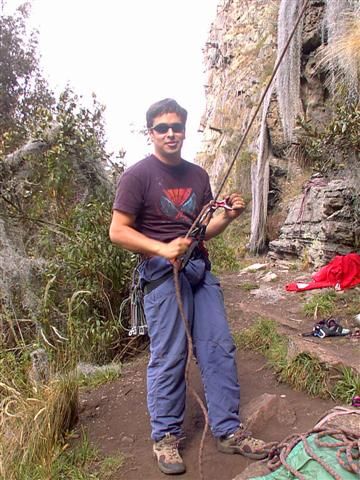 Rope over his shoulder, at the foot of the route